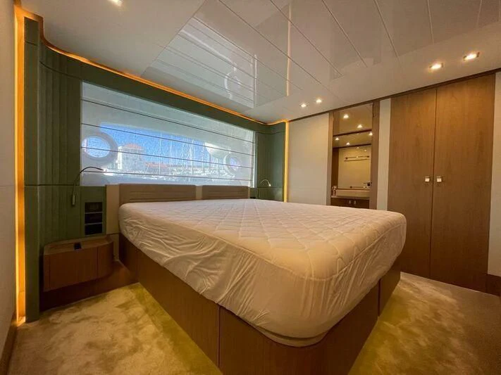 a room with a bed and a window aboard KATARIINA XO Yacht for Sale