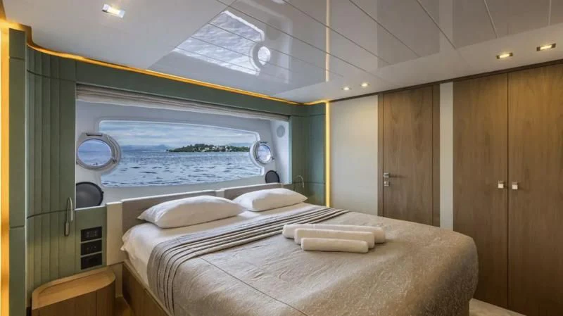 a room with a bed and a window aboard KATARIINA XO Yacht for Sale
