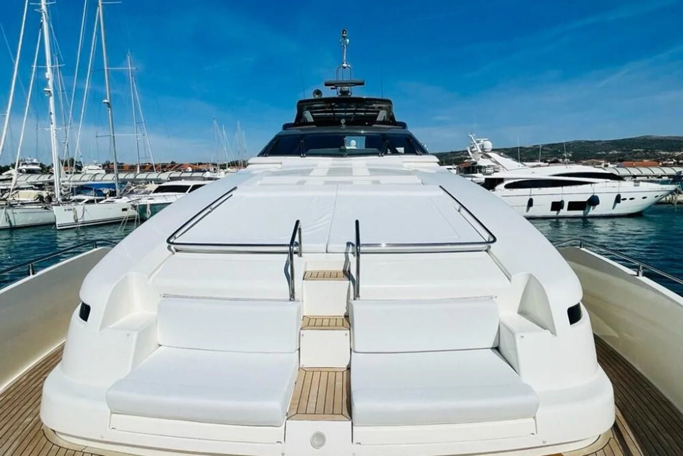 a white yacht in a harbor aboard KATARIINA XO Yacht for Sale