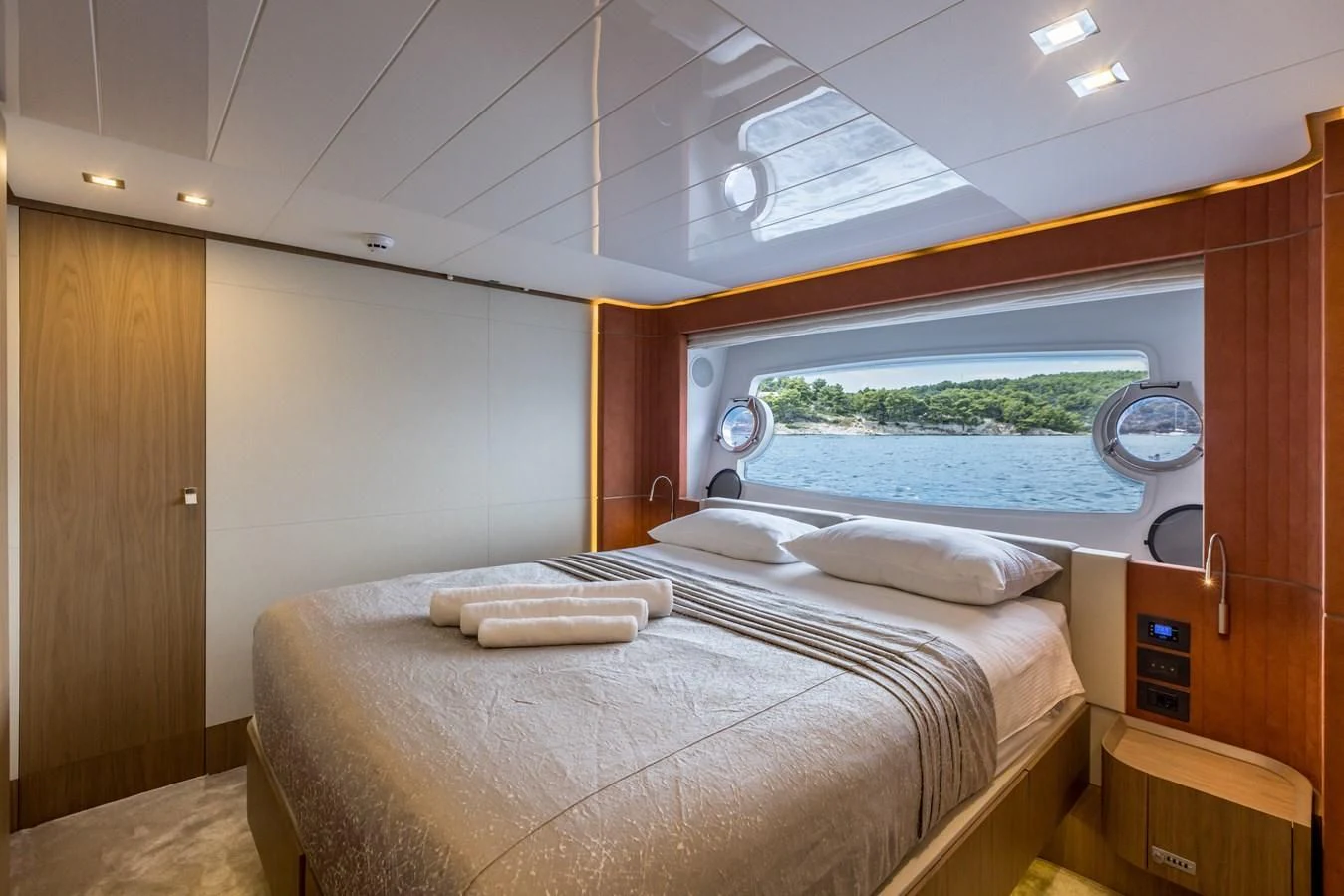 a bedroom with a large window aboard KATARIINA XO Yacht for Sale