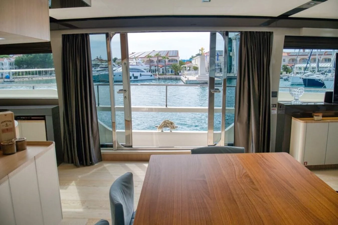 a room with a table and a window aboard KATARIINA XO Yacht for Sale
