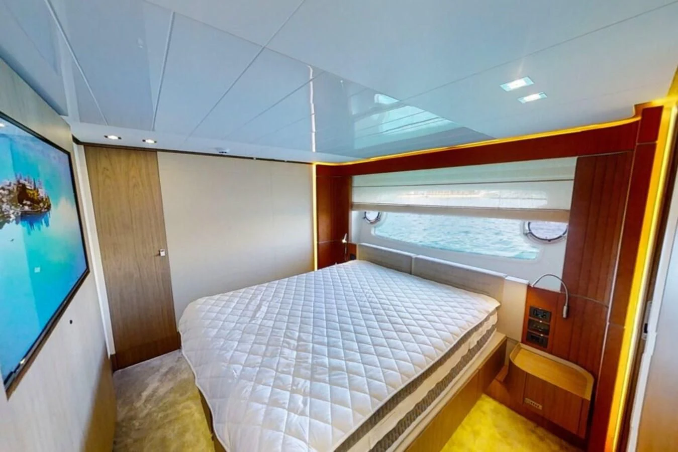 a bedroom with a bed and a window aboard KATARIINA XO Yacht for Sale