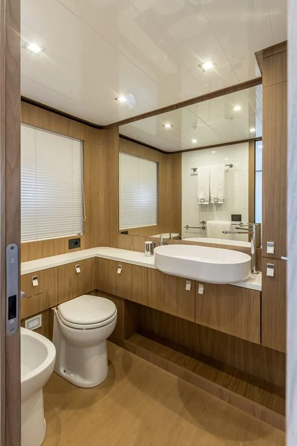 a bathroom with a sink toilet and a mirror aboard KATARIINA XO Yacht for Sale
