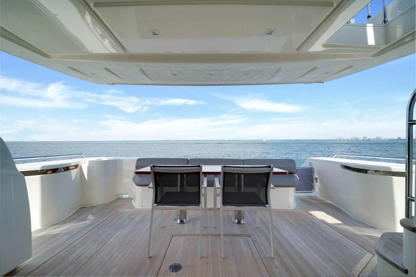 a deck with chairs and a table on it aboard KATARIINA XO Yacht for Sale