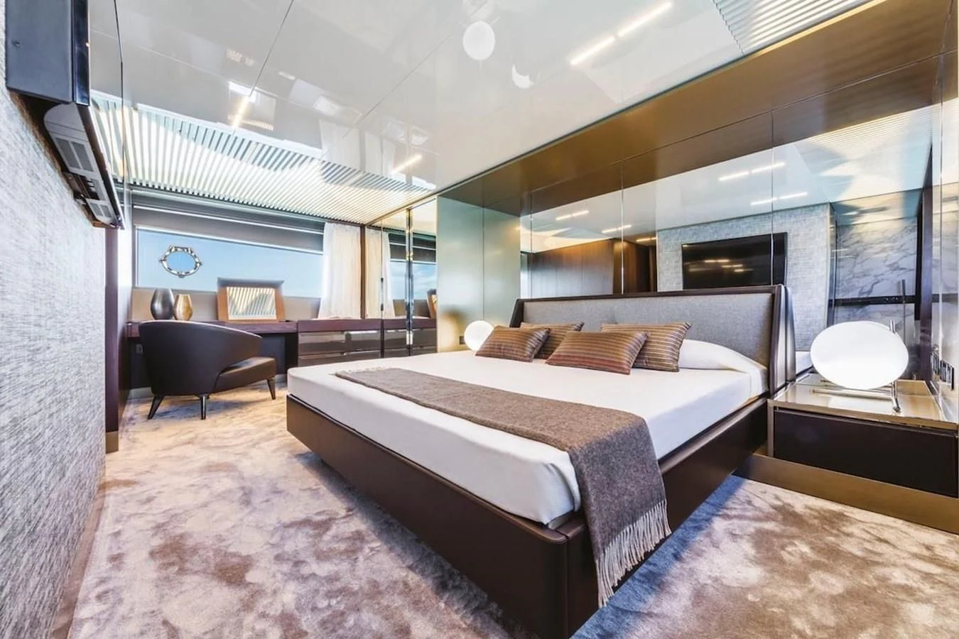 a bedroom with a bed and a chair aboard KATARIINA XO Yacht for Sale