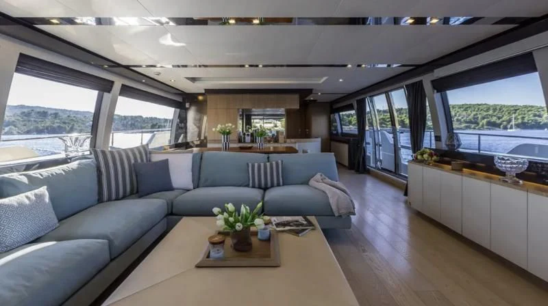a living room with a large window aboard KATARIINA XO Yacht for Sale