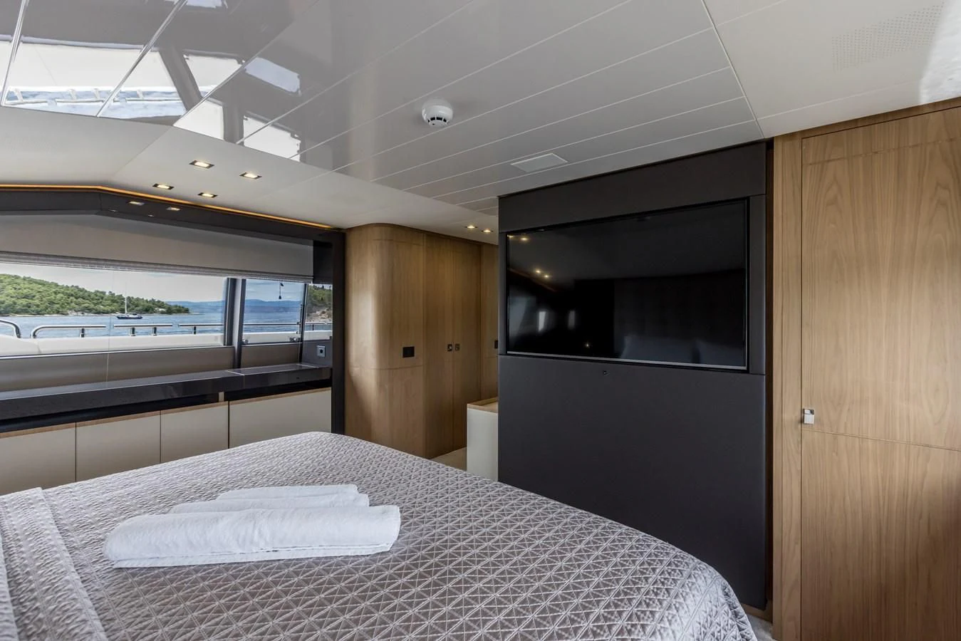 a room with a table and a bed aboard KATARIINA XO Yacht for Sale