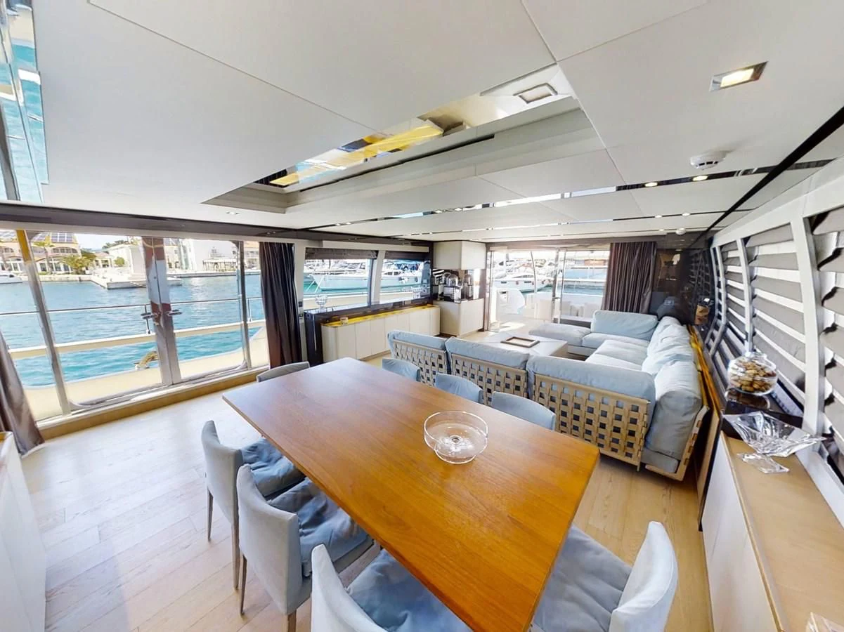 a large living room with a table and chairs aboard KATARIINA XO Yacht for Sale