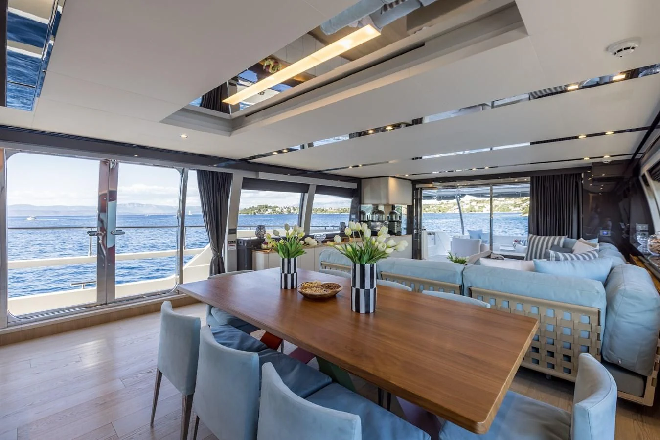 a large room with a table and chairs aboard KATARIINA XO Yacht for Sale