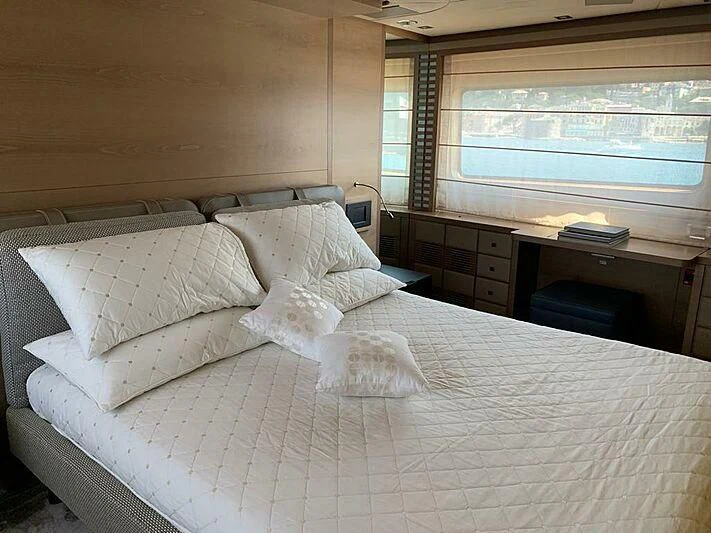 a bed with white sheets aboard SERENITY MIA Yacht for Sale