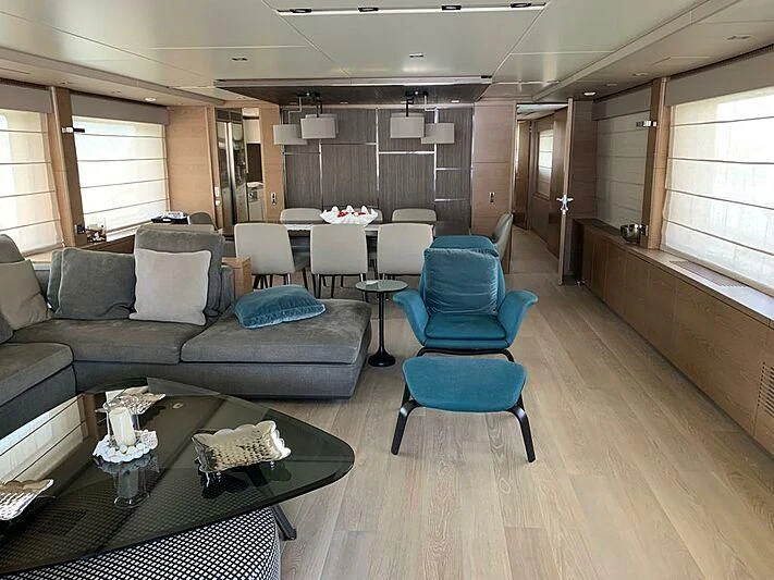 a living room with a couch and a table aboard SERENITY MIA Yacht for Sale
