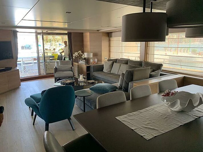 a living room with a large window aboard SERENITY MIA Yacht for Sale