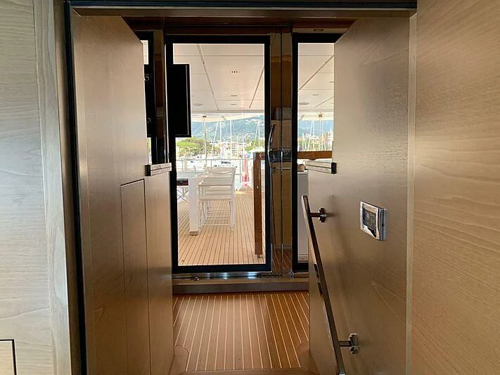 a room with glass doors aboard SERENITY MIA Yacht for Sale