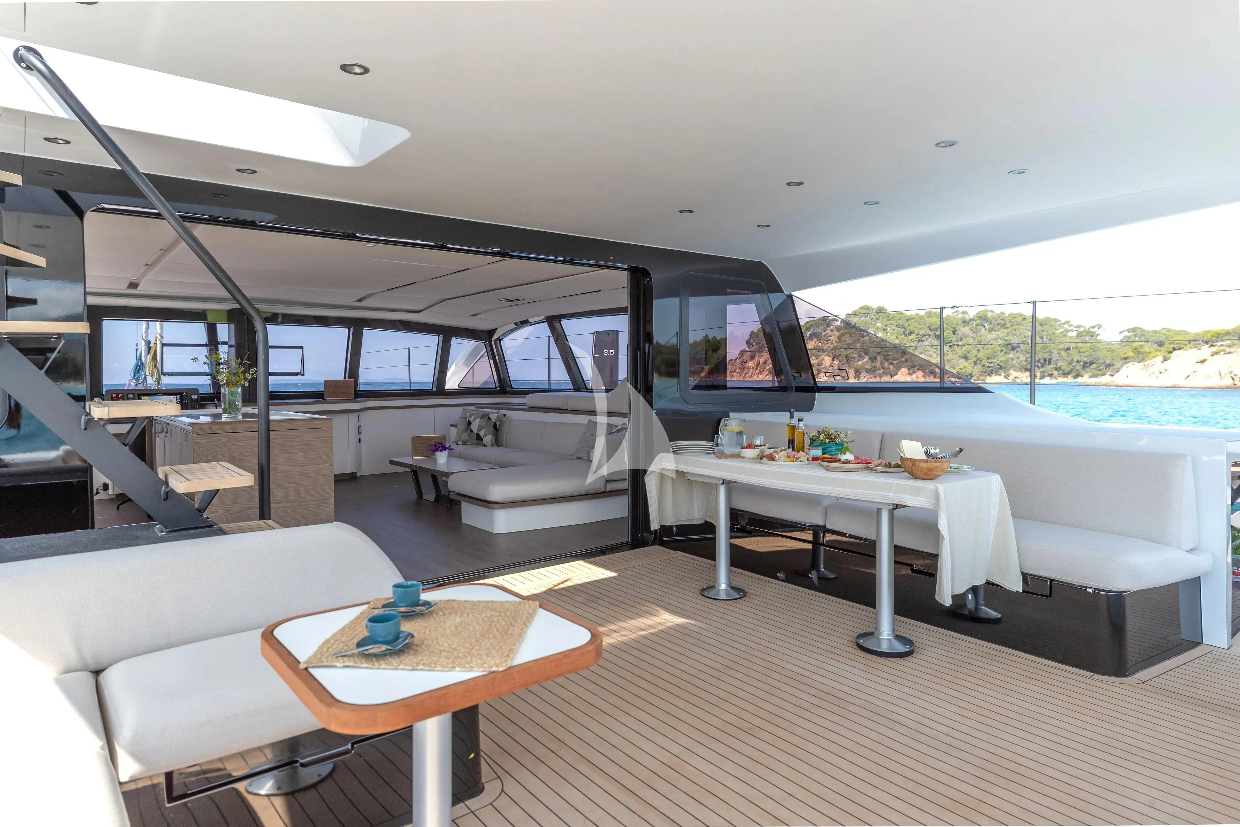 a living room with a large white table and a large window aboard WONDERFUL Yacht for Charter
