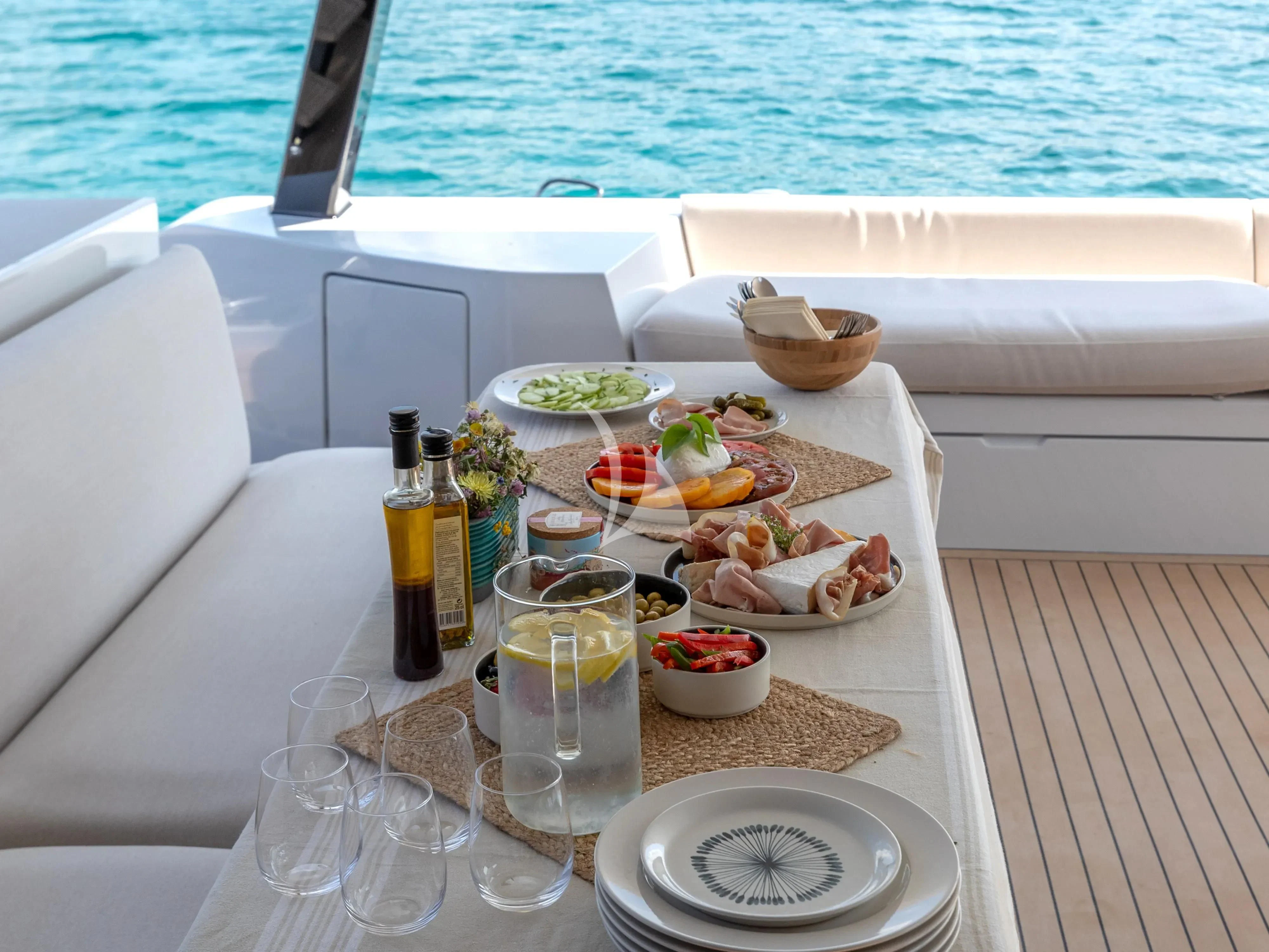 a table with food and drinks on it aboard WONDERFUL Yacht for Charter
