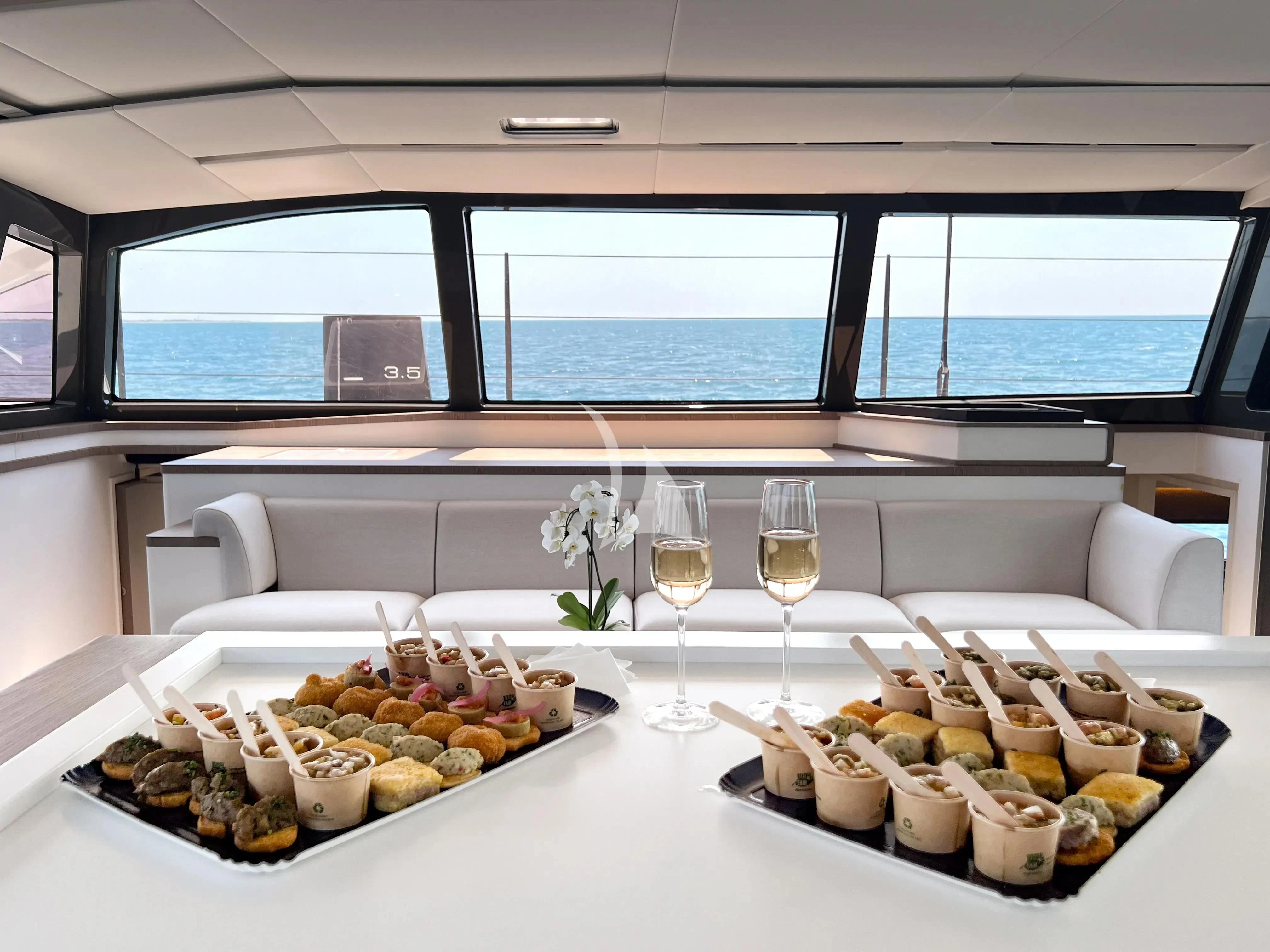 a table with food and wine glasses aboard WONDERFUL Yacht for Charter