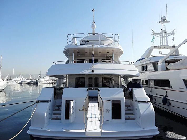 a large white boat in a harbor aboard INSPIRATION Yacht for Sale