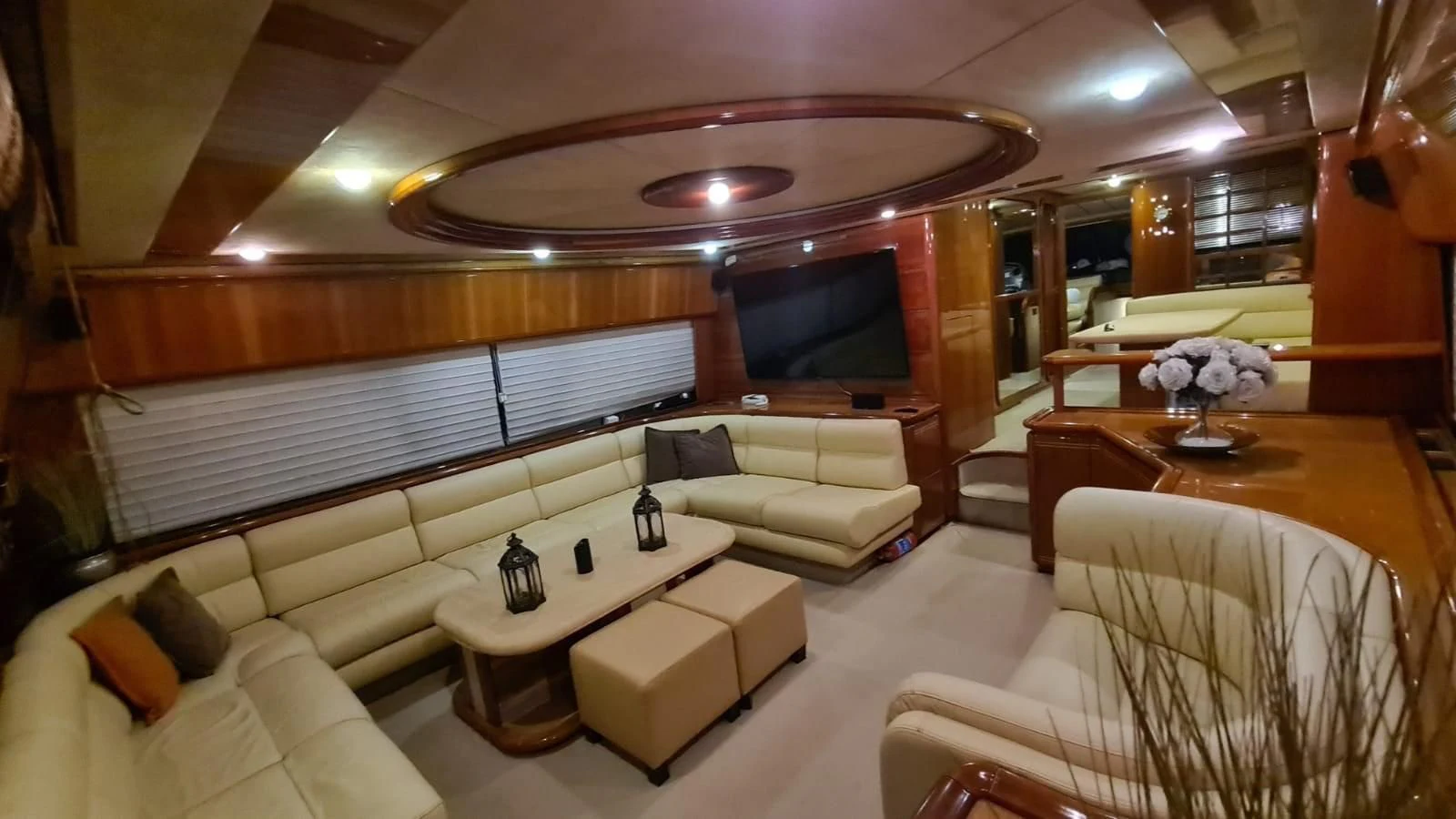 a room with a couch and a table and a television aboard 2000 FERRETTI  80 Yacht for Sale