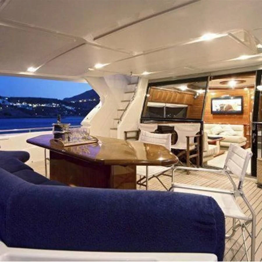 a room with a table and chairs aboard 2000 FERRETTI  80 Yacht for Sale