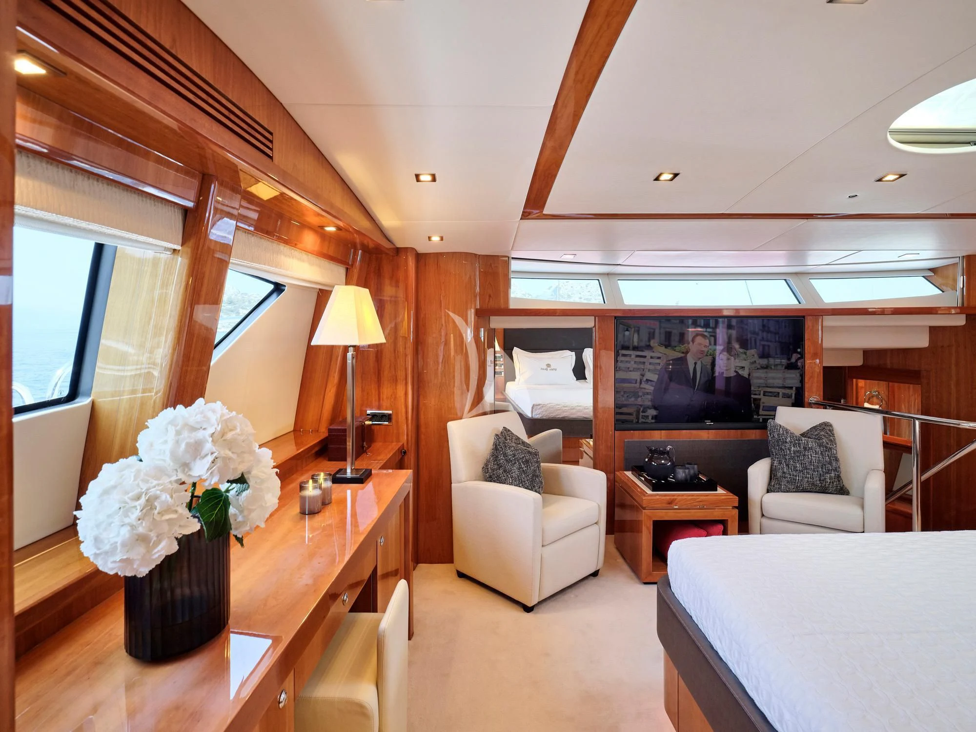 a living room with a tv and flowers aboard WHITE PEARL I Yacht for Sale