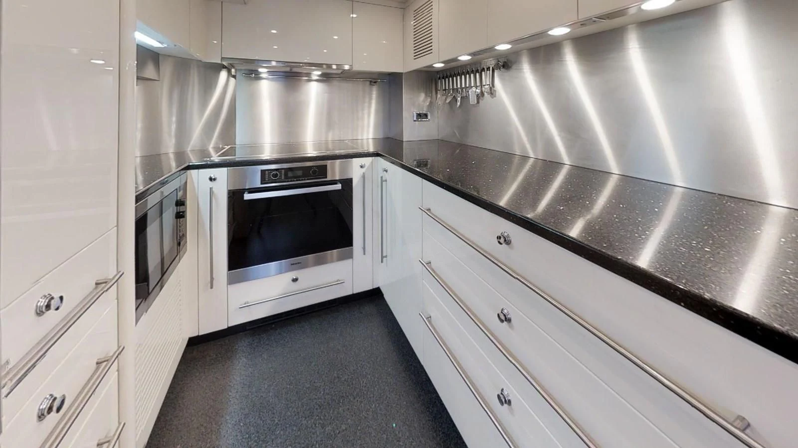 a kitchen with stainless steel appliances aboard WHITE PEARL I Yacht for Sale