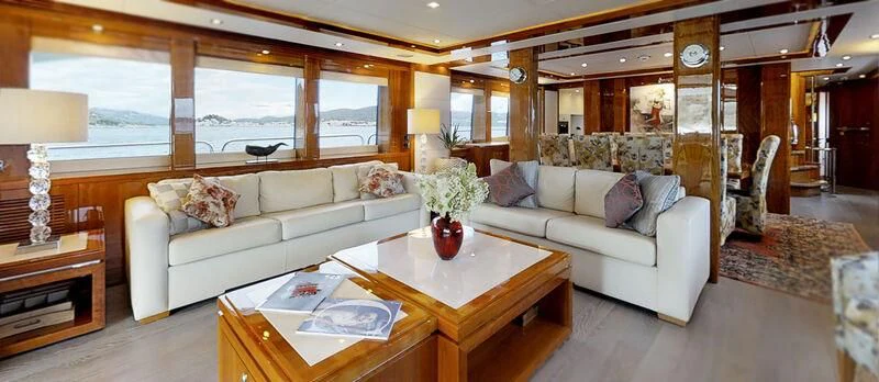 a living room with a white couch and a coffee table aboard WHITE PEARL I Yacht for Sale