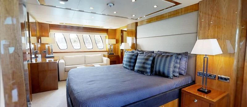 a bedroom with a bed and a lamp aboard WHITE PEARL I Yacht for Sale