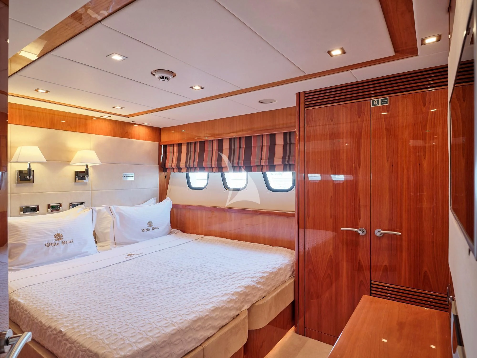 a bedroom with a bed and a closet aboard WHITE PEARL I Yacht for Sale