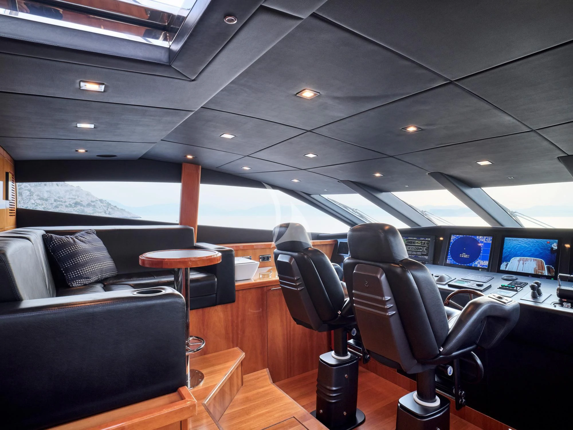 inside of a vehicle with seats and a view of the water aboard WHITE PEARL I Yacht for Sale