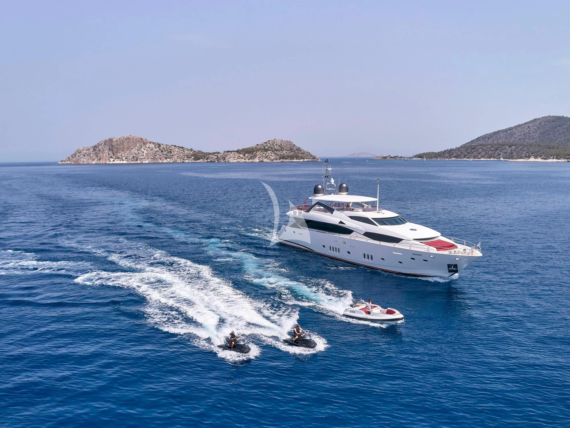 a boat and a motor boat on the water aboard WHITE PEARL I Yacht for Sale