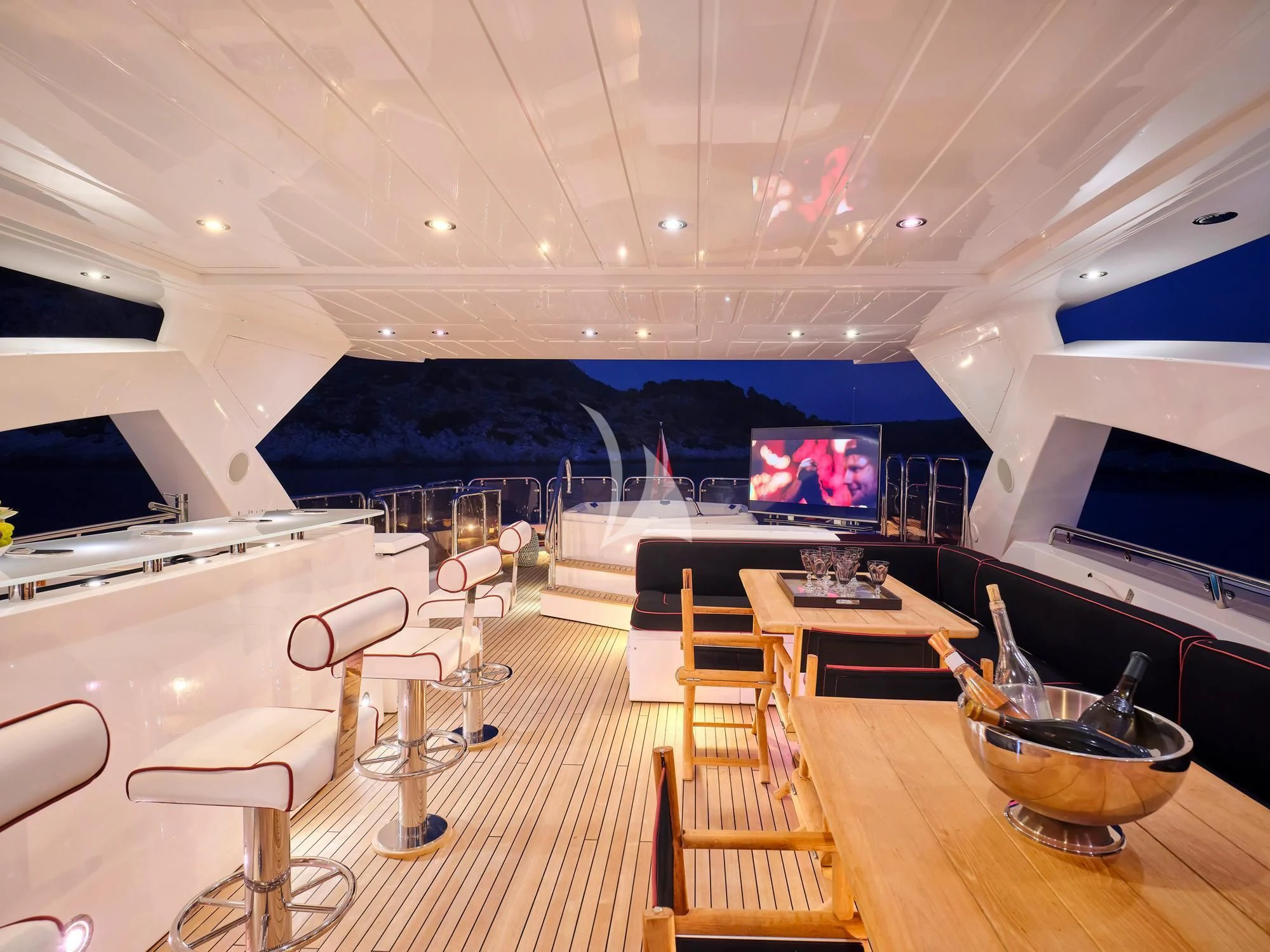 a room with a large television and tables and chairs aboard WHITE PEARL I Yacht for Sale