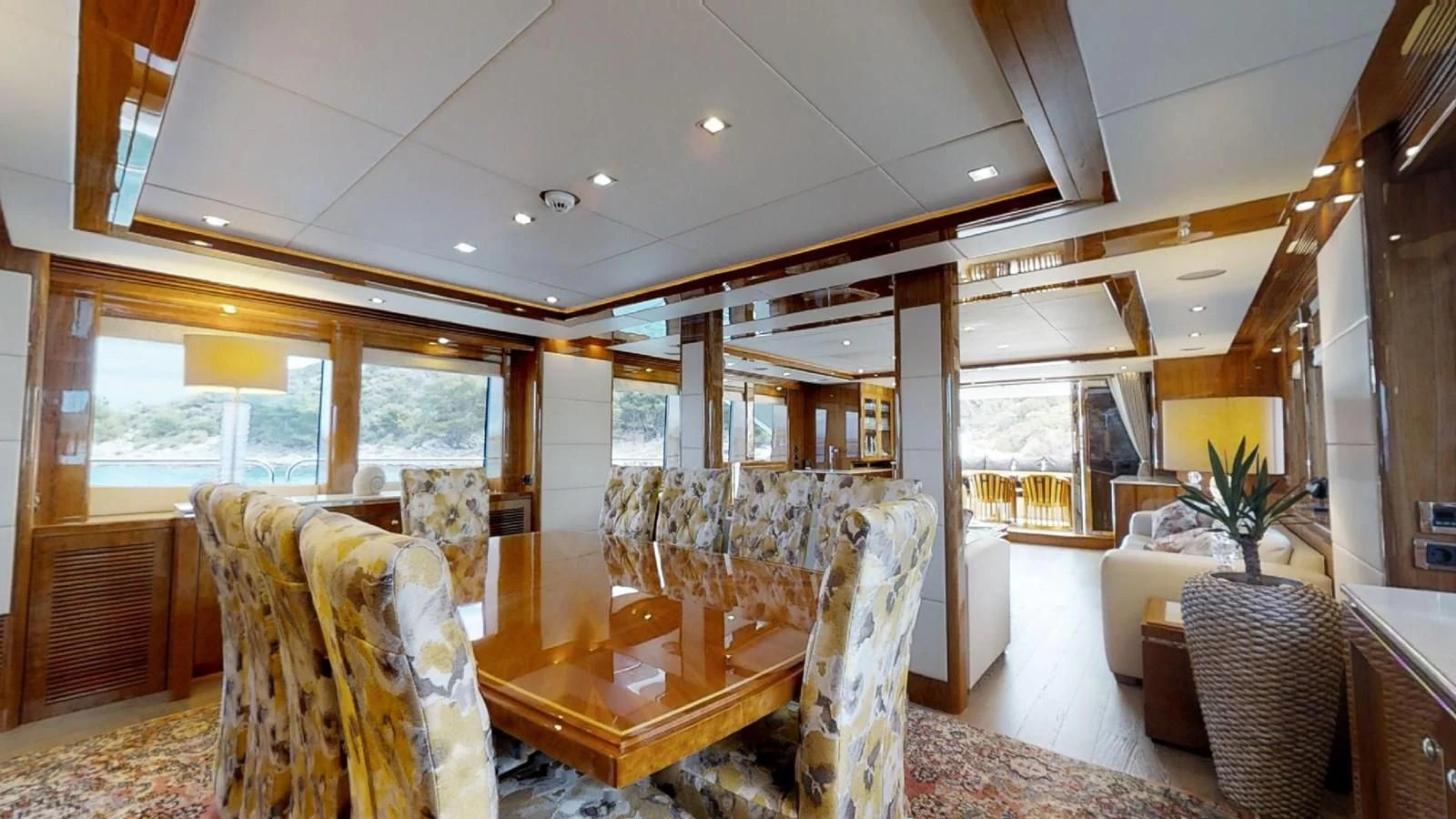 a large living room with a dining table and chairs aboard WHITE PEARL I Yacht for Sale