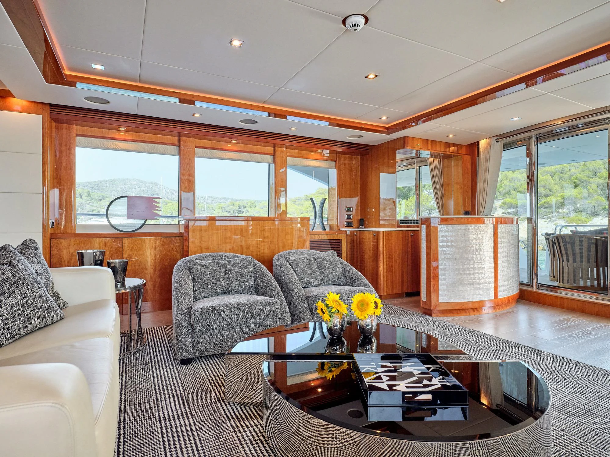 a living room with a large glass coffee table and a large window aboard WHITE PEARL I Yacht for Sale