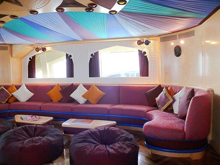 a room with a couch and a window aboard HAPPY LIFE Yacht for Sale