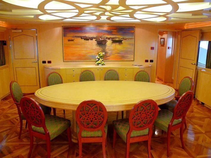 a table with chairs around it aboard HAPPY LIFE Yacht for Sale