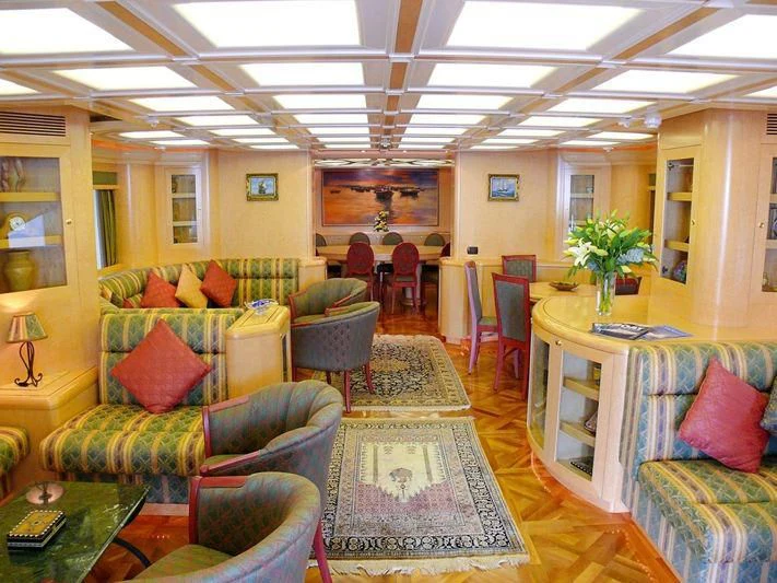 a living room with a couch and chairs aboard HAPPY LIFE Yacht for Sale