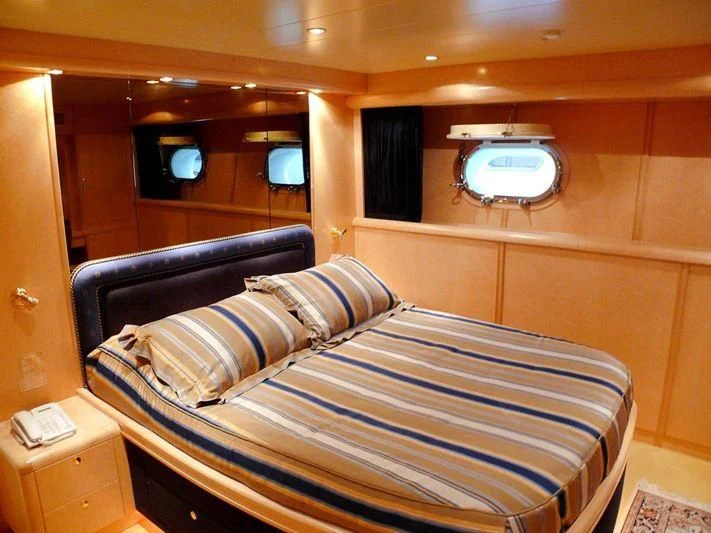 a bed with a blue cover aboard HAPPY LIFE Yacht for Sale