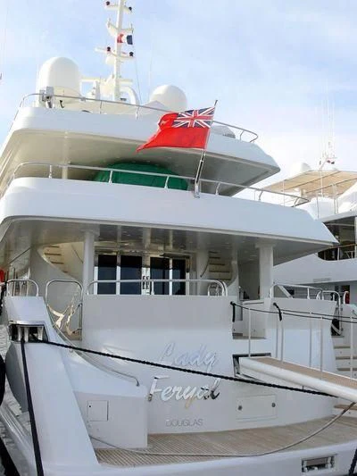 a boat with a flag on the front aboard HAPPY LIFE Yacht for Sale