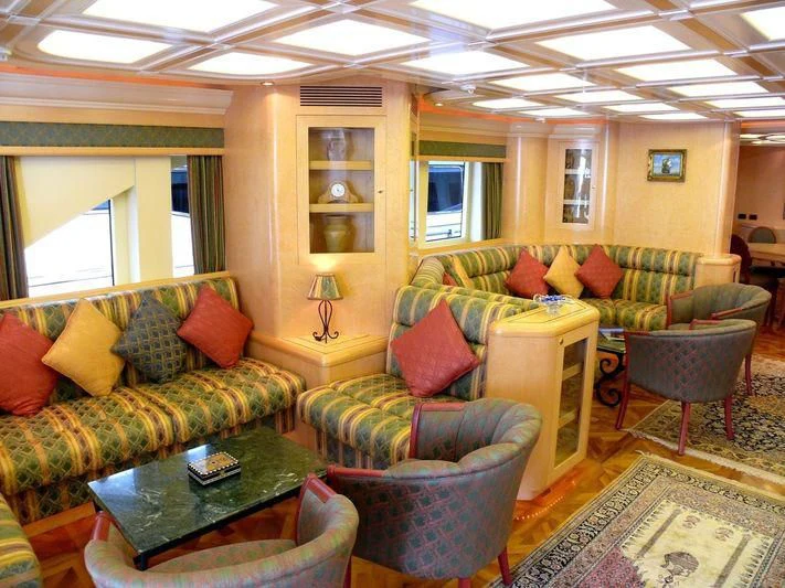 a living room with couches and a coffee table aboard HAPPY LIFE Yacht for Sale