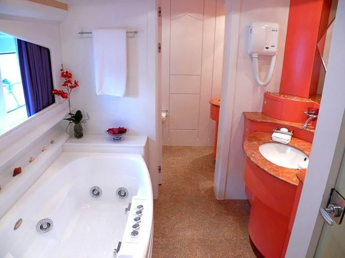 a bathroom with a tub sink and a sink aboard HAPPY LIFE Yacht for Sale