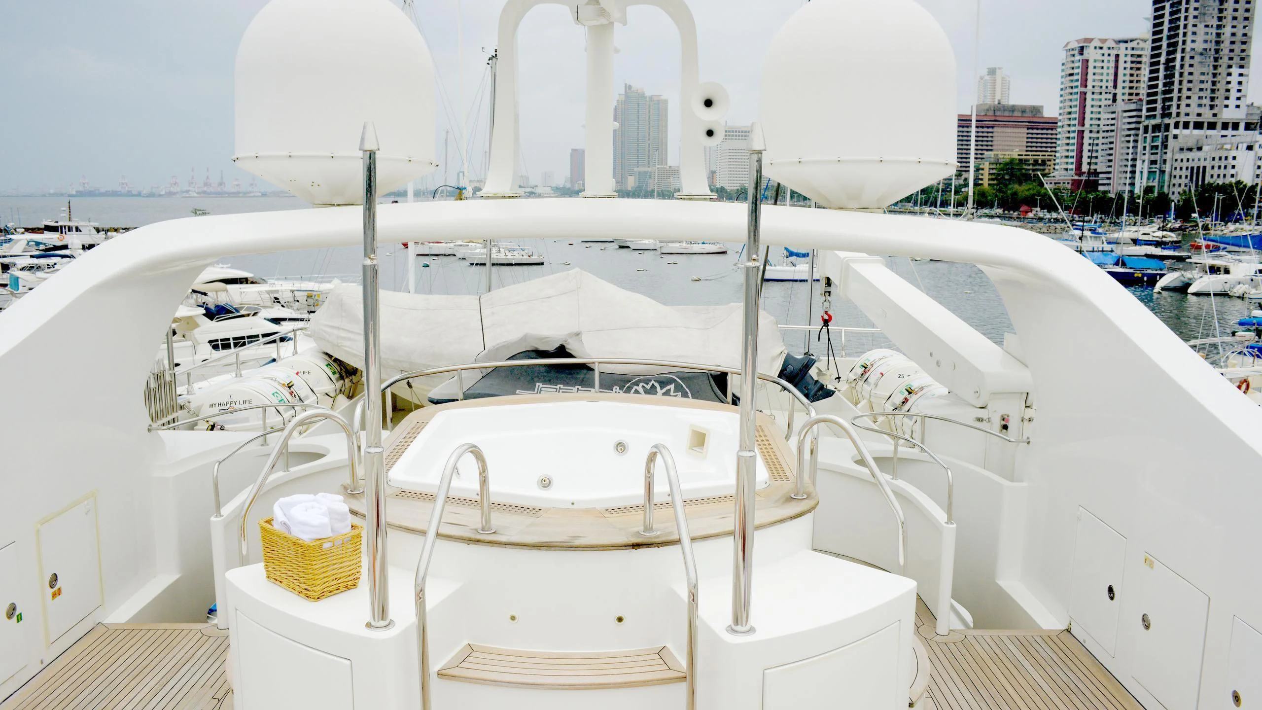 a white boat with a white canopy aboard HAPPY LIFE Yacht for Sale