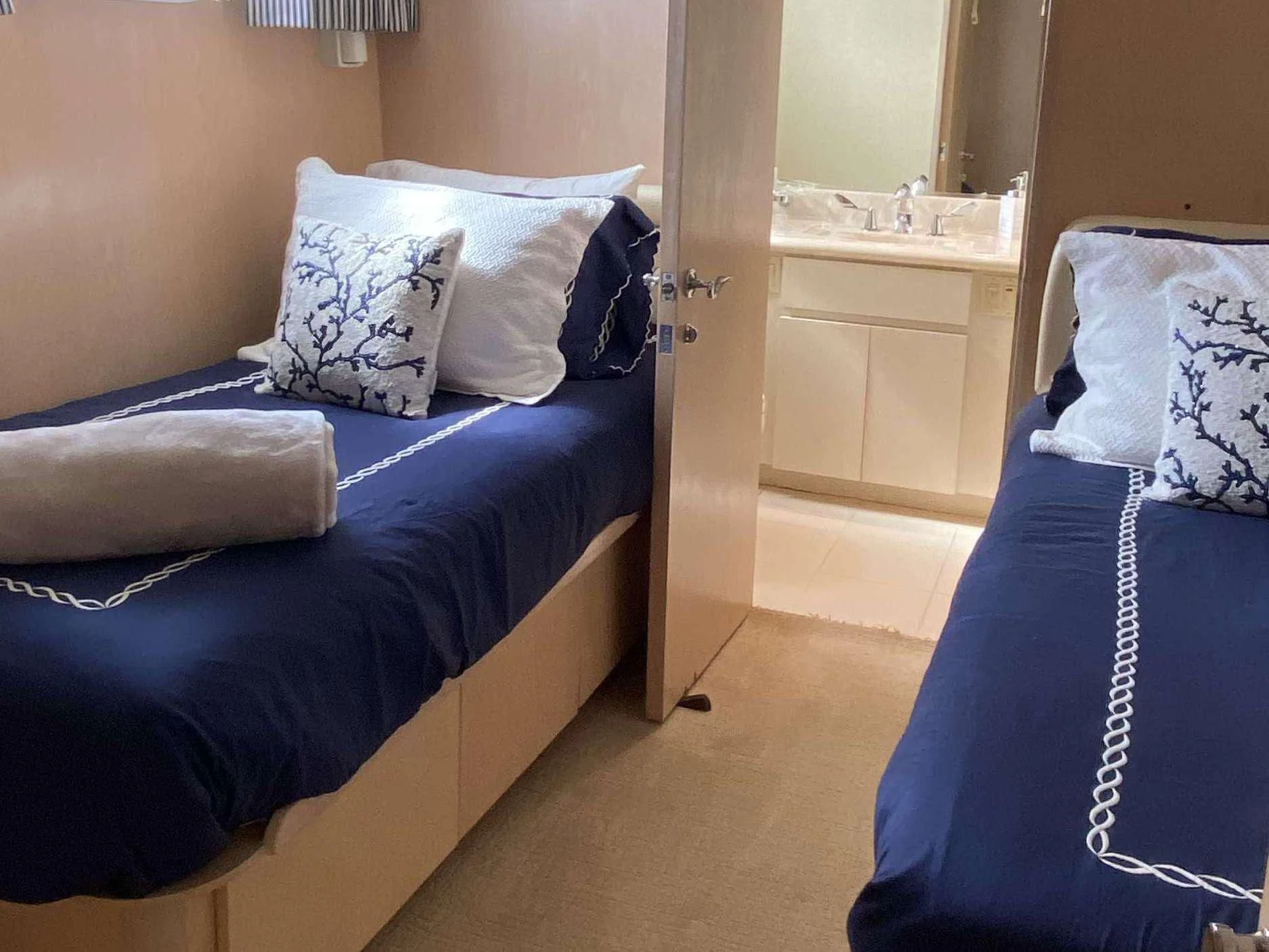 a room with a bed and a blue blanket aboard LADY GRAY Yacht for Sale