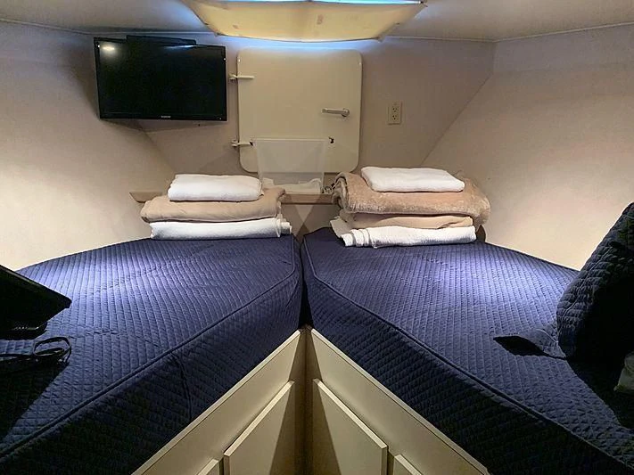 a room with a bed and a tv on the wall aboard LADY GRAY Yacht for Sale