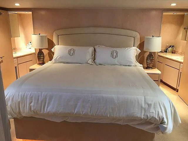 a bed with white sheets aboard LADY GRAY Yacht for Sale