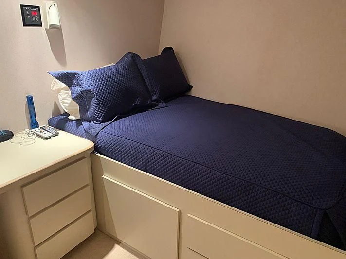 a bed with a blue comforter aboard LADY GRAY Yacht for Sale