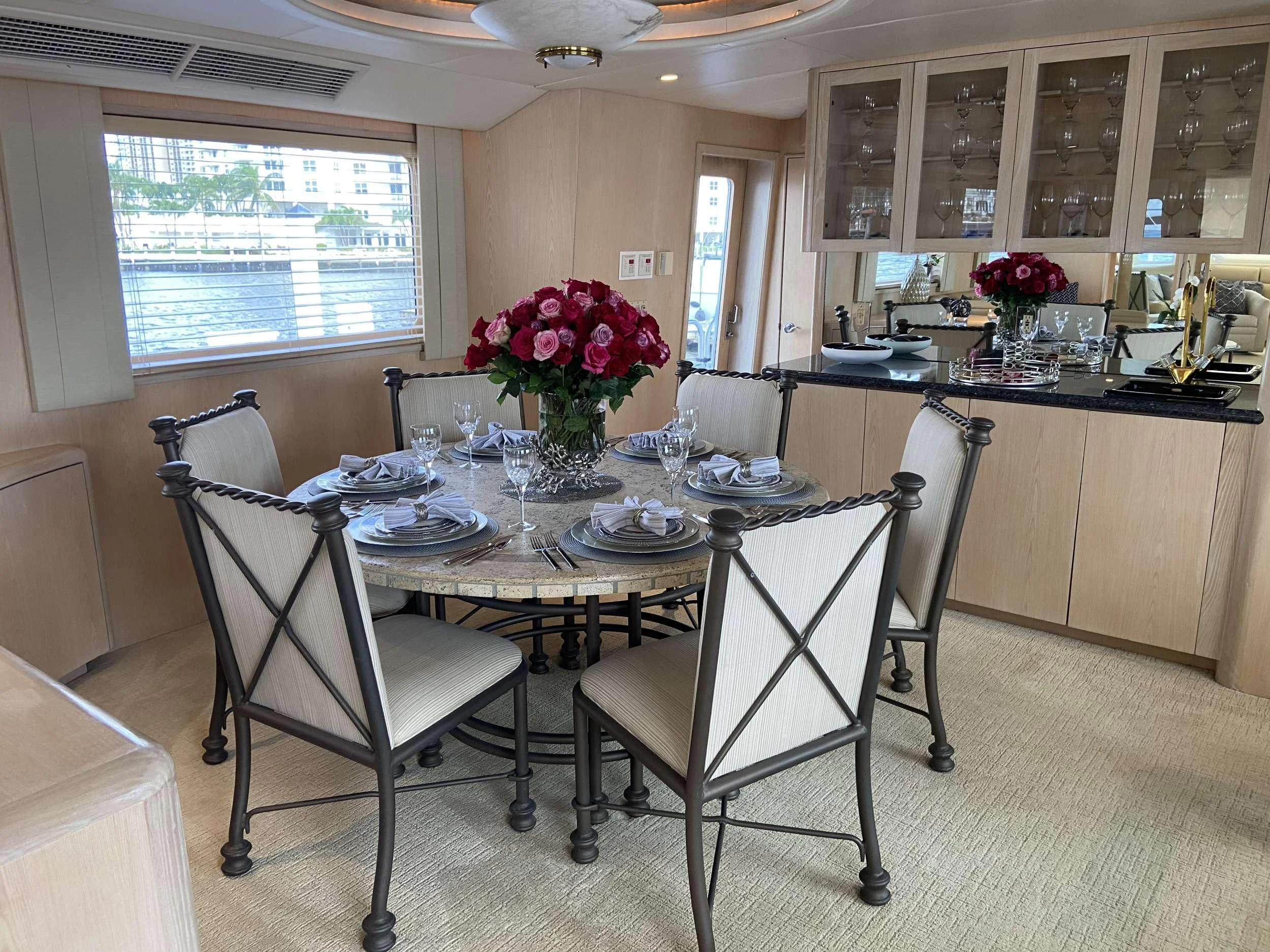a dining room with a table and chairs aboard LADY GRAY Yacht for Sale