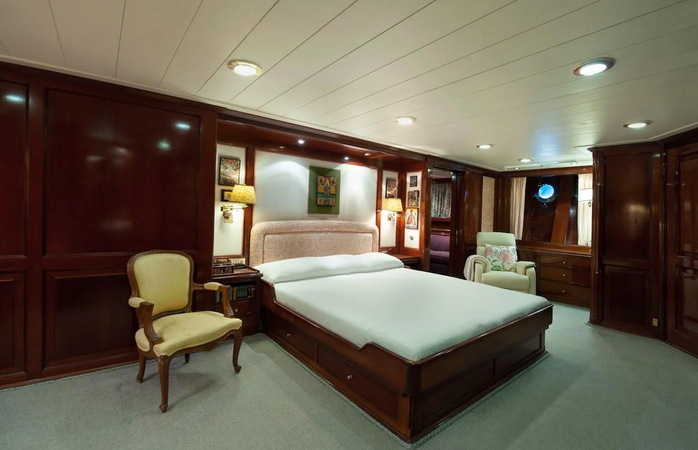 a bedroom with a bed and a chair aboard BELLE BRISE Yacht for Sale