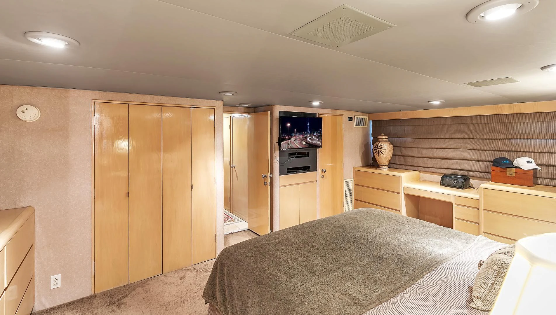 a bedroom with a bed and a closet aboard LA VIDA Yacht for Sale