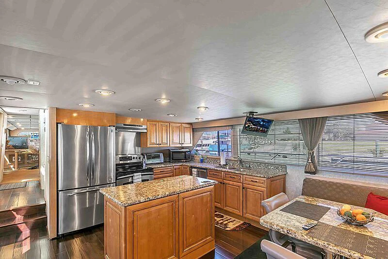 a kitchen with a stainless steel refrigerator aboard LA VIDA Yacht for Sale
