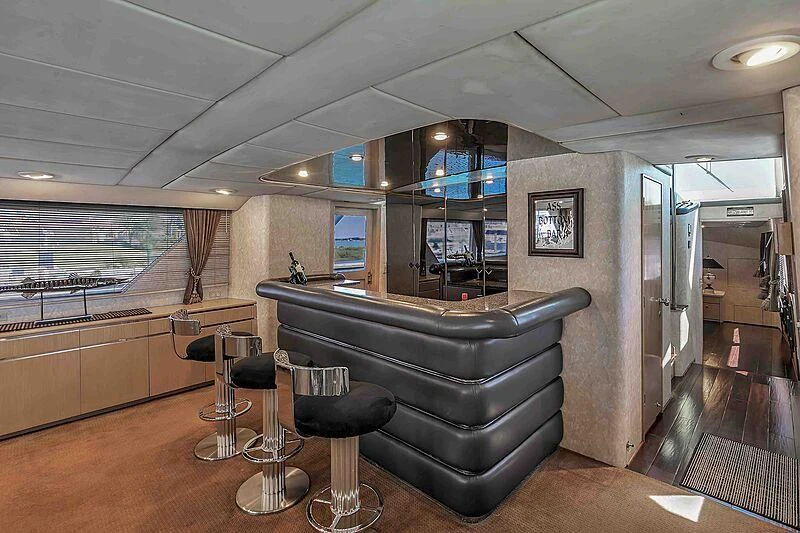 a large living room with a large sofa and a large window aboard LA VIDA Yacht for Sale